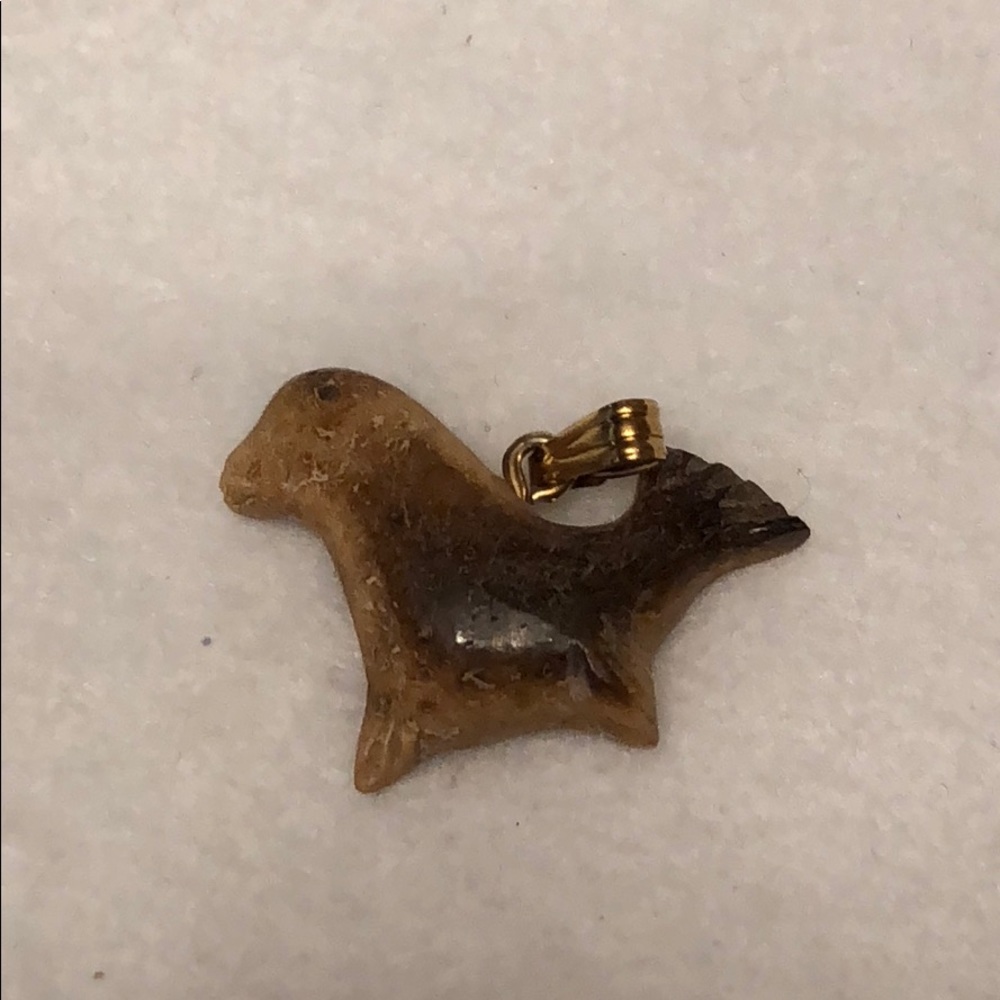 Seal carved fossilized whale bone pendant